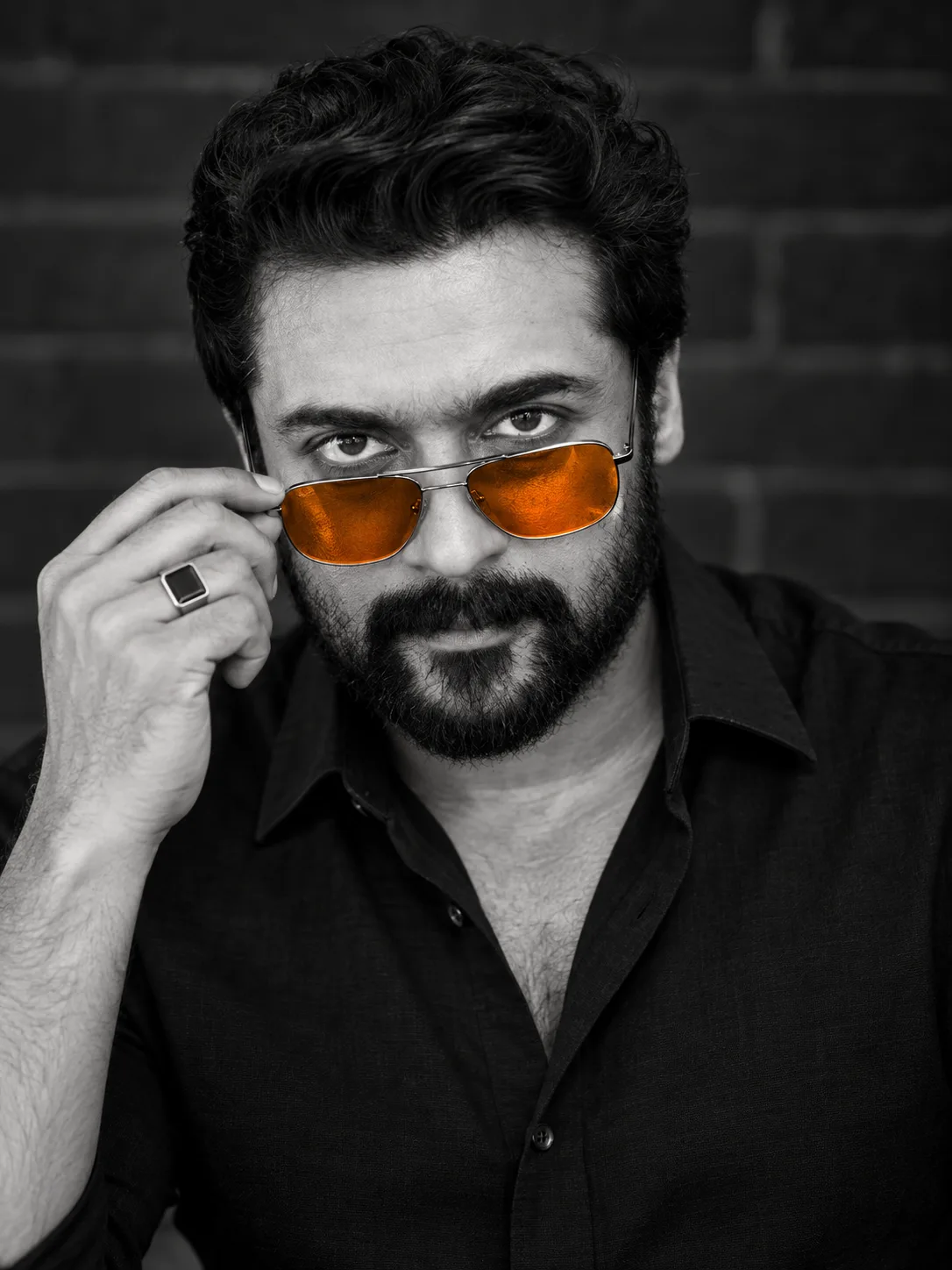 high-contrast b&w close-up portrait with orange aviators