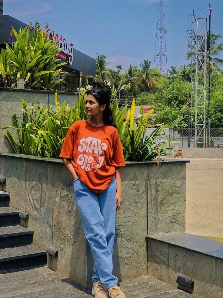 Candid Outdoor Street Portrait of Young Indian Woman in Oversized Orange Tee