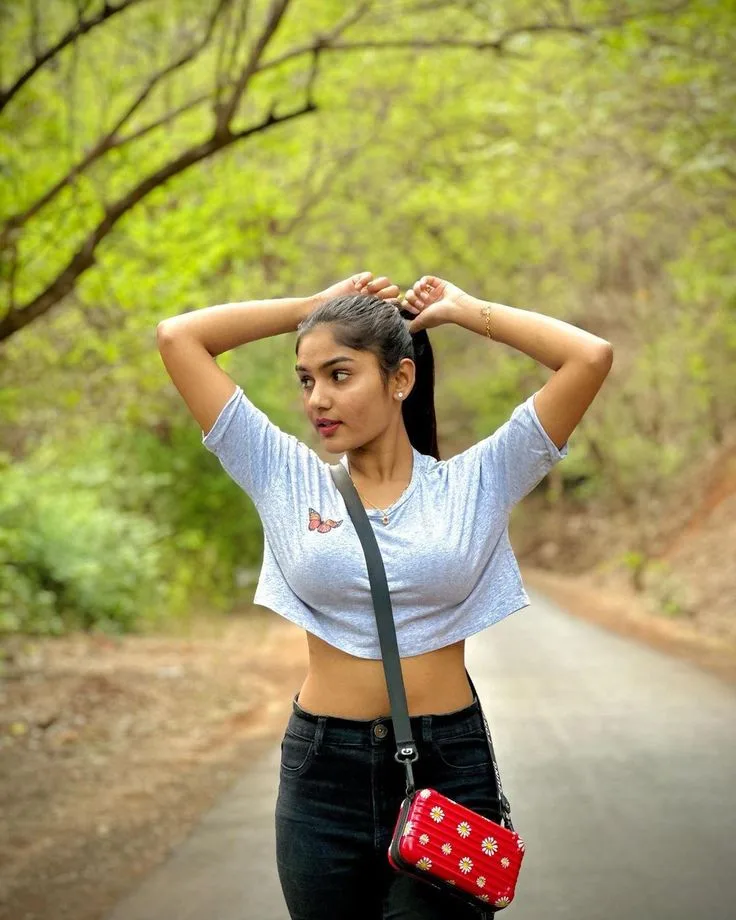 Candid Forest Road Portrait of Young Woman Tying Hair