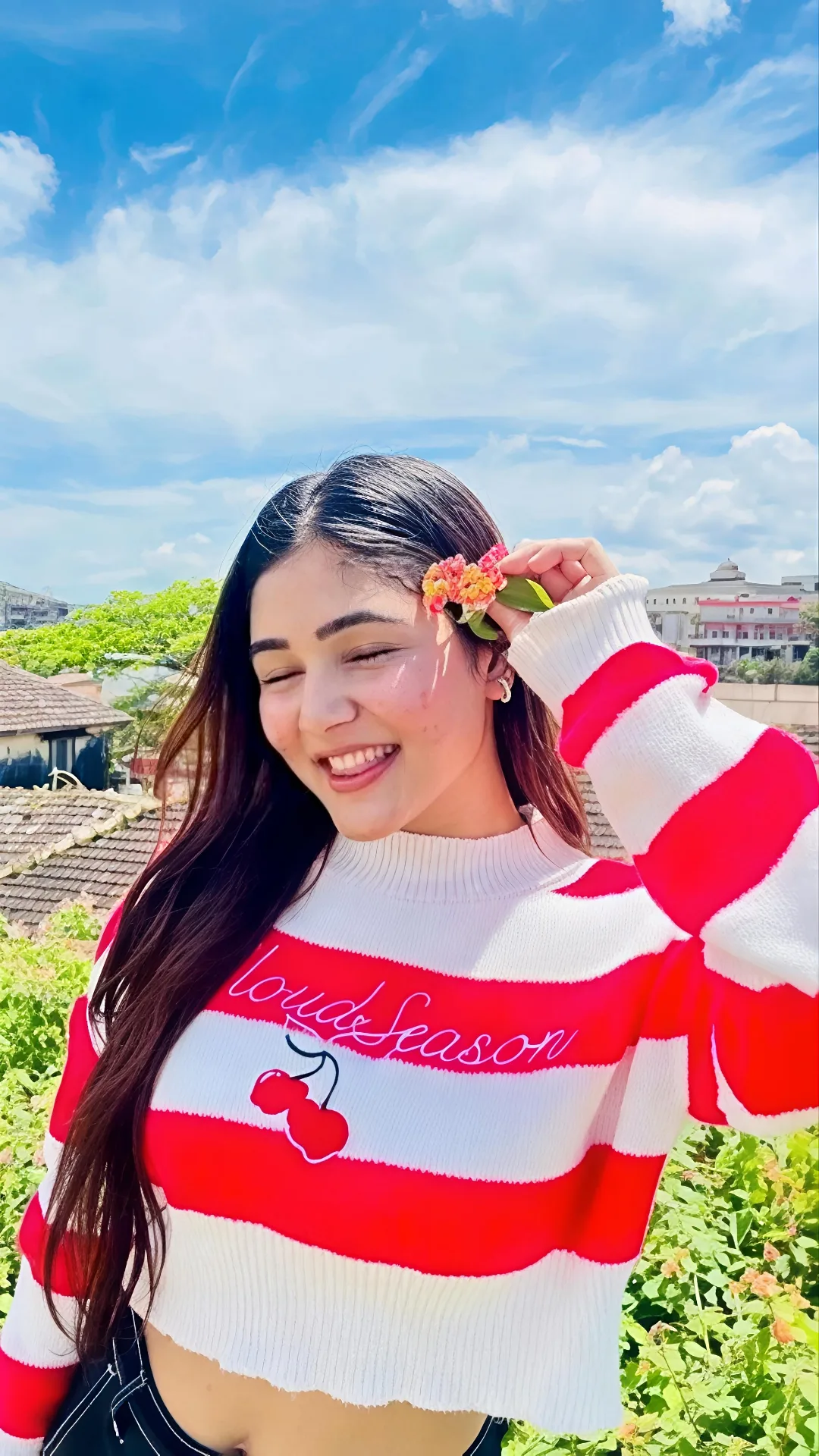 Playful Outdoor Portrait in Red and White Striped Cropped Sweater