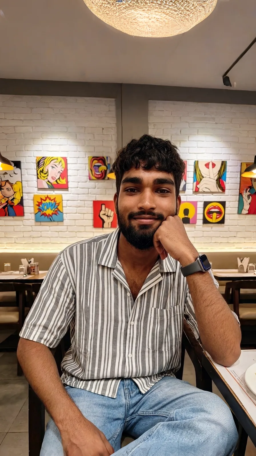 Candid Restaurant Portrait of Young Man Leaning on Hand