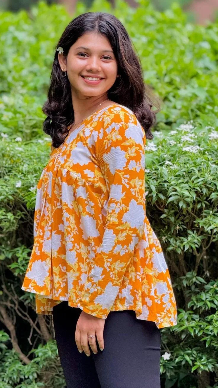 Cheerful Female Garden Portrait in Floral Peplum Top with Flower in Hair Prompt
