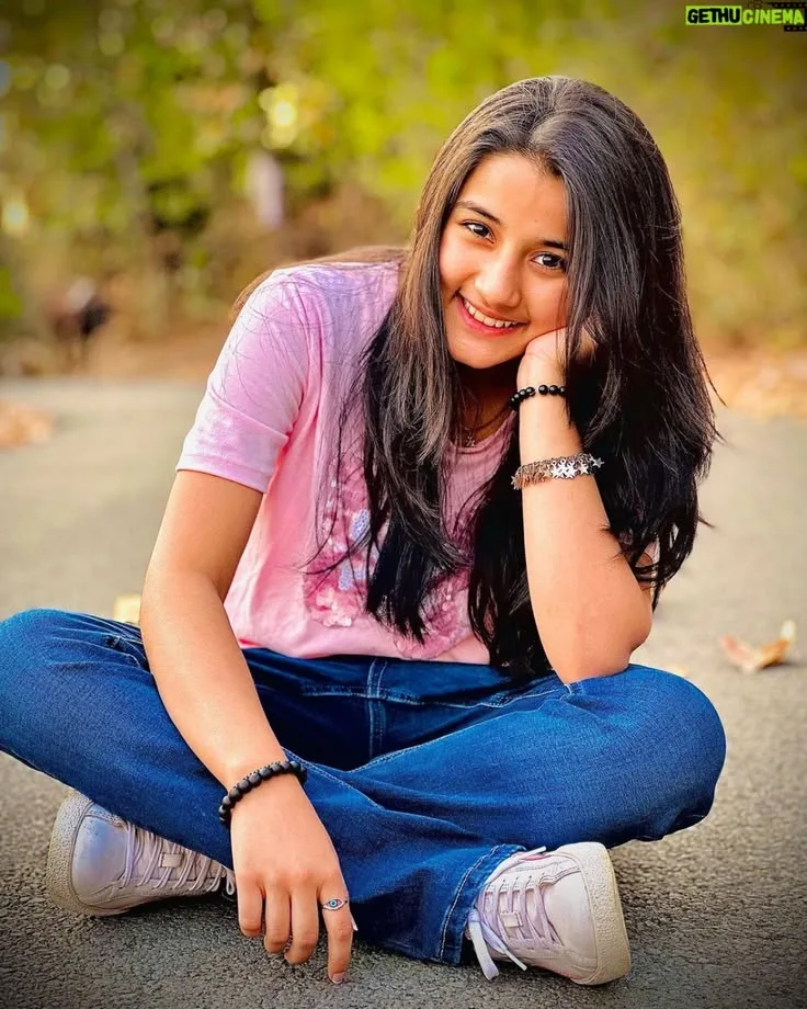 Cheerful Female Portrait Sitting Cross-Legged on Outdoor Road Prompt