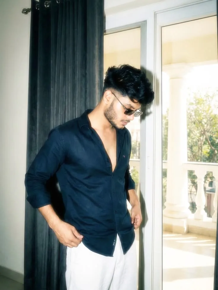 Candid Balcony Doorway Portrait of Young Man in Black Button-Up Shirt