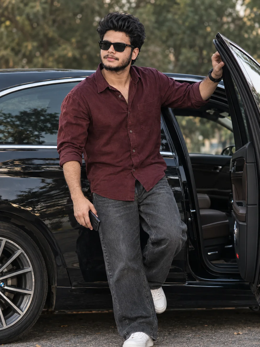 Stylish Young Man Posing with Black BMW