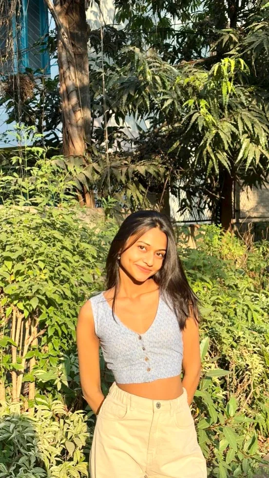 Candid Sunlit Garden Portrait of Young Woman in Crop Top and Khakis