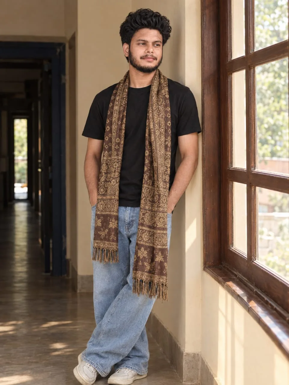 Casual Young Man in Patterned Scarf Leaning by Hallway Window