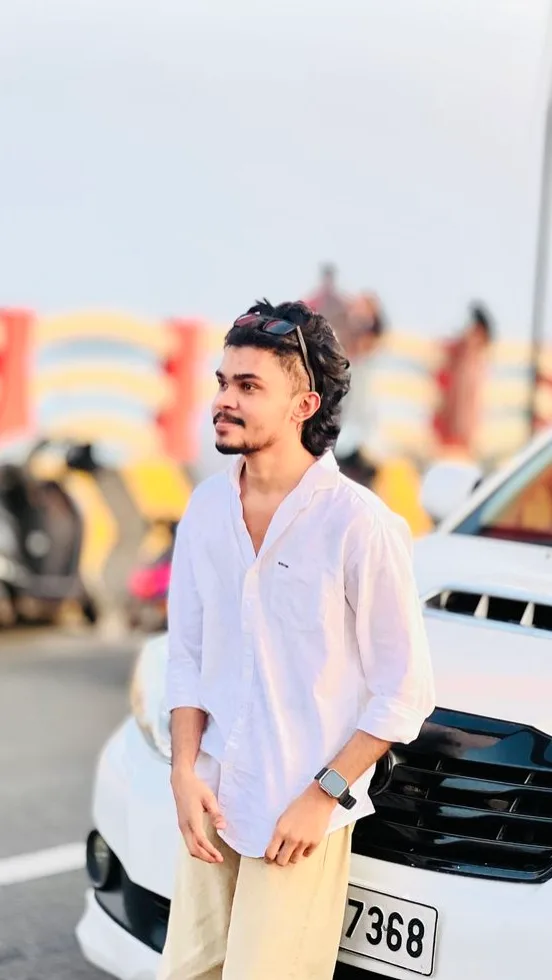 Candid Outdoor Portrait of Young Man Leaning on White SUV