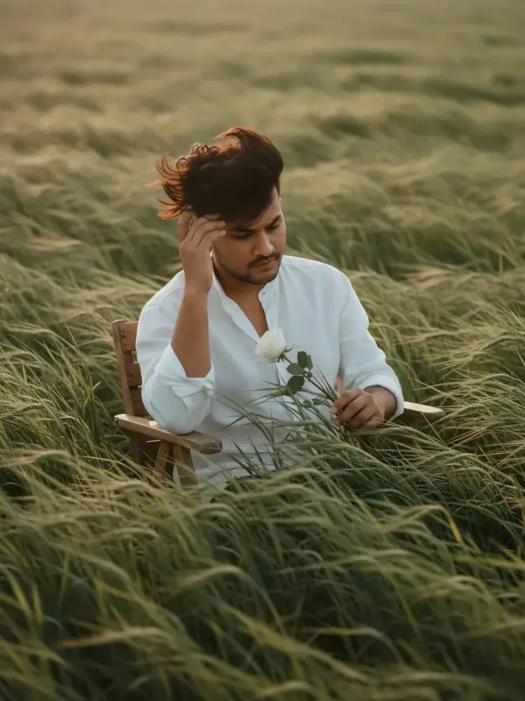 cinematic editorial portrait of a man sitting on a simple chair.