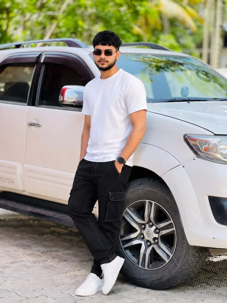 Candid Outdoor Portrait of Young Man Leaning Against White SUV