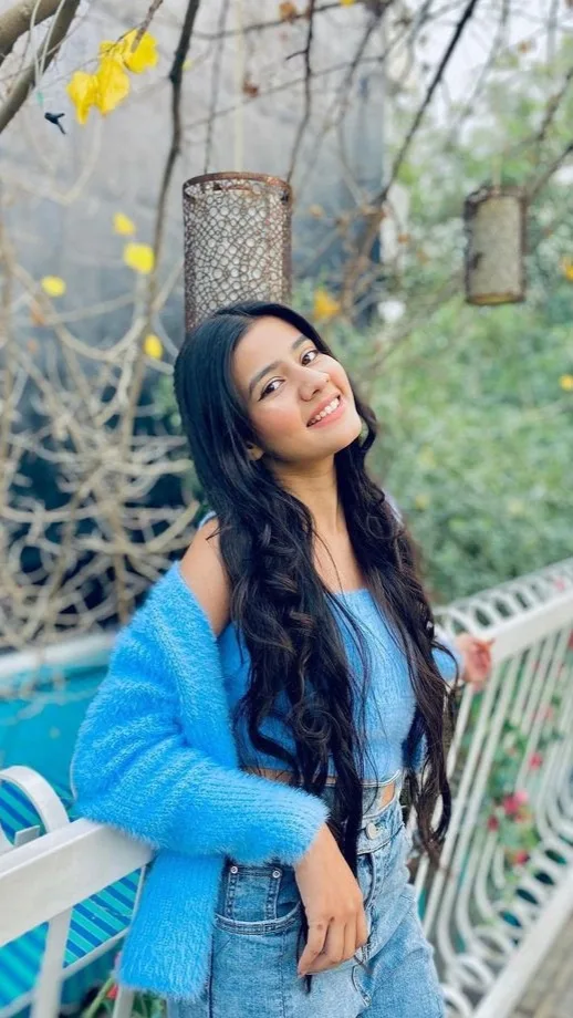 Candid Garden Terrace Portrait of Young Woman in Fuzzy Blue Cardigan