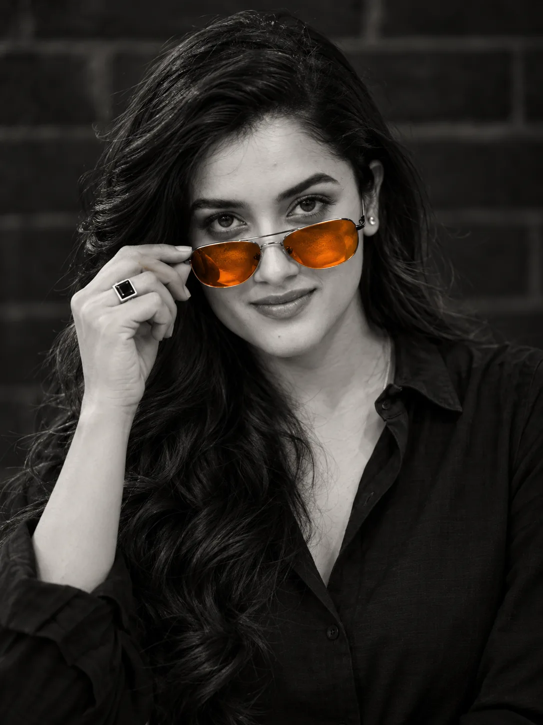 high-contrast b&w close-up portrait with orange aviators