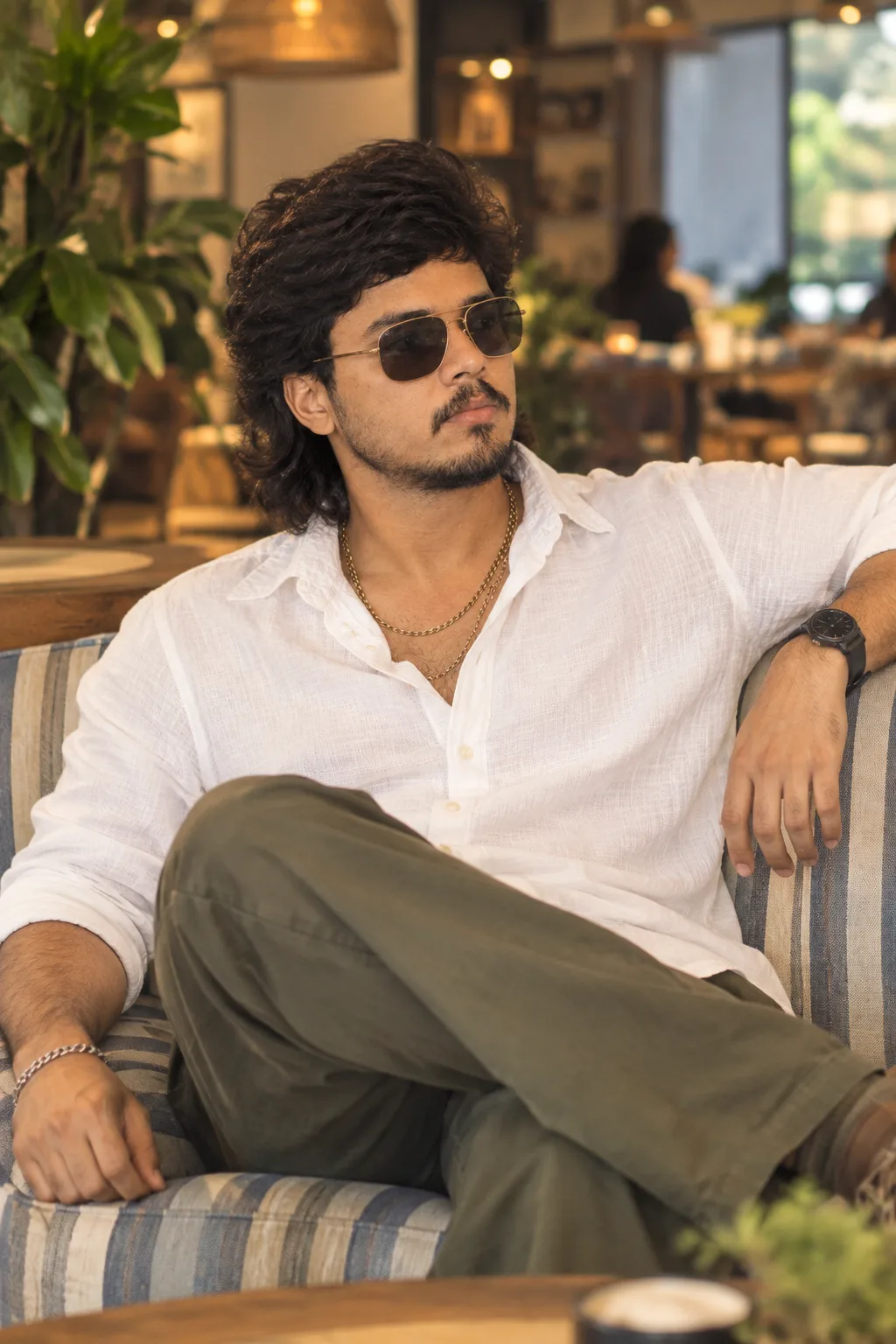 Ultra realistic cinematic cafe portrait of a young man sitting in a sofa