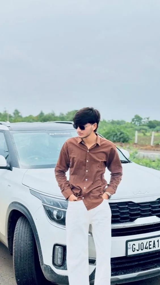 Candid Outdoor Portrait of Young Man Leaning on White SUV