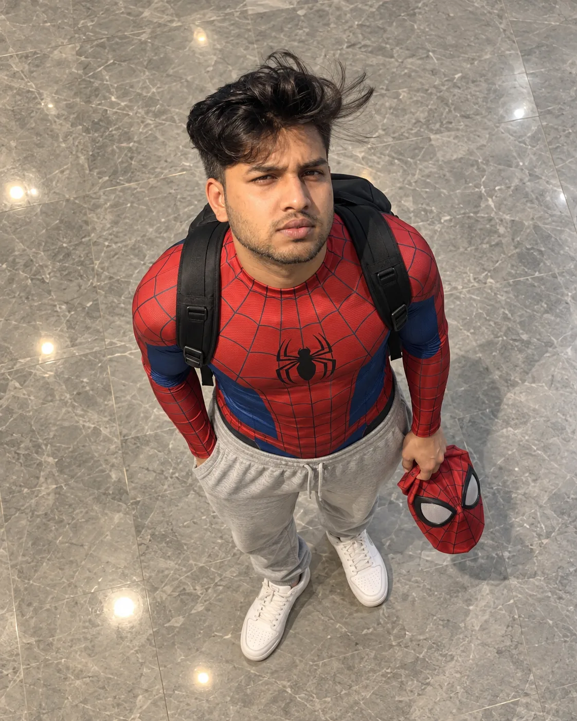 Use the uploaded image as the PRIMARY VISUAL REFERENCE. Recreate the same full-body overhead portrait of a young man sta