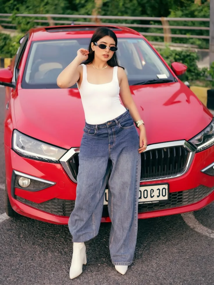 Candid Street Style Portrait of Indian Woman Leaning on Red Sedan