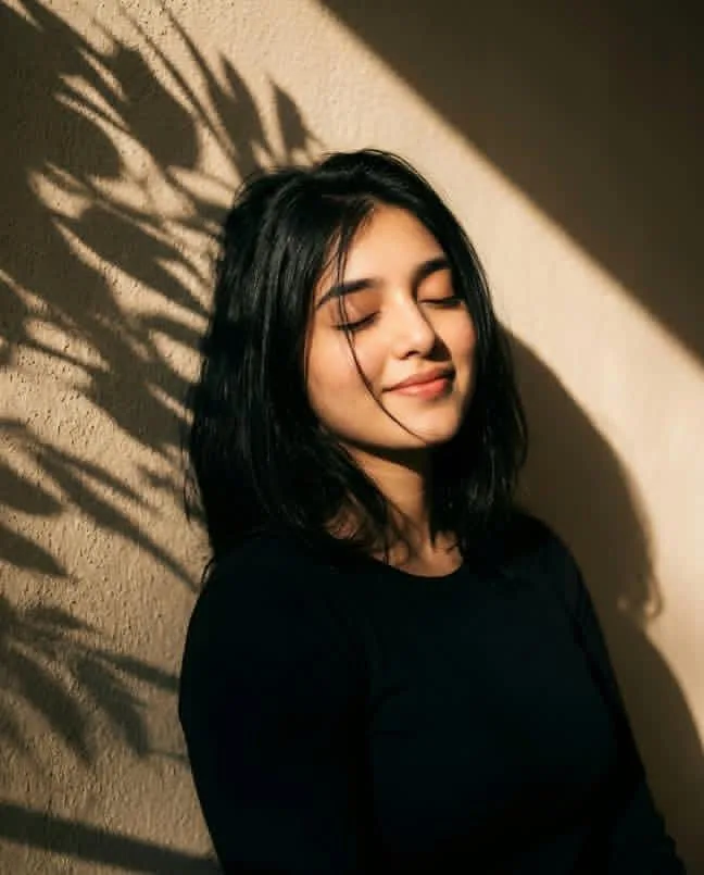 Serene Sun-Kissed Portrait with Leaf Shadows