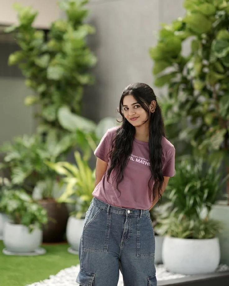 Candid Garden Portrait of Young Indian Woman in Mauve Tee and Baggy Jeans
