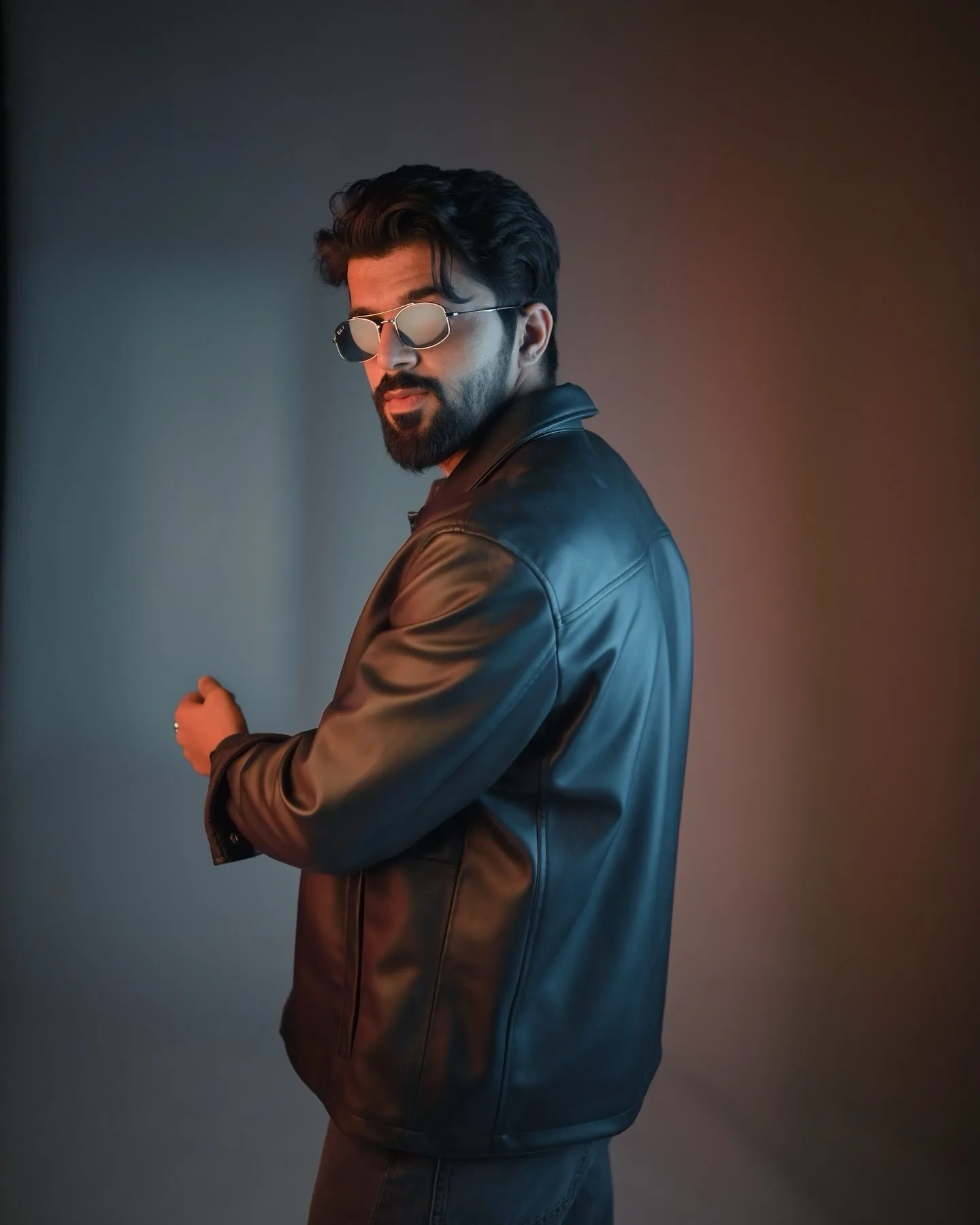 Dual-Tone Leather Jacket Over-the-Shoulder Studio Portrait