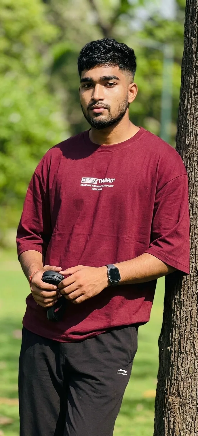 Candid Outdoor Park Portrait of Young Man Leaning on Tree Trunk