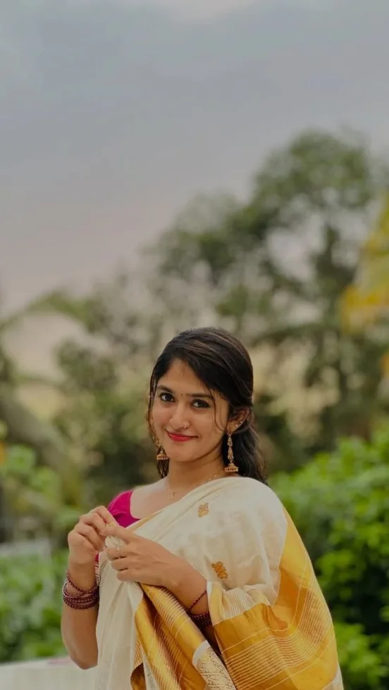 Candid Outdoor Portrait in Traditional Kasavu Saree