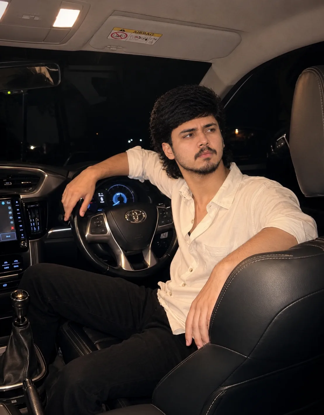 Young Man Sitting in a Car at Night – Cinematic Portrait