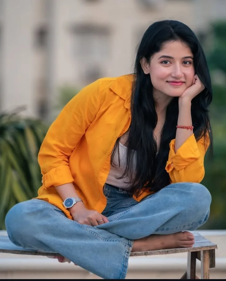 Candid Female Rooftop Portrait in Yellow Oversized Shirt Sitting Cross-Legged Prompt