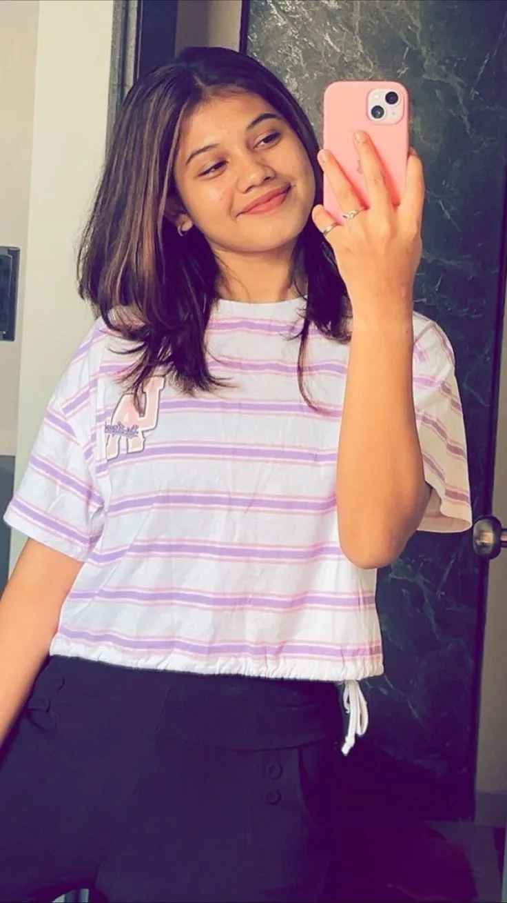 Candid Indoor Mirror Selfie of Young Woman in Striped Tee