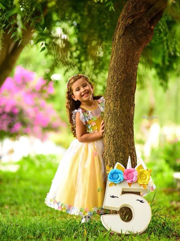 Joyful 5th Birthday Outdoor Portrait of Little Girl Beside Tree Trunk Prompt