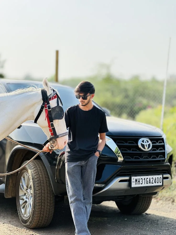 Candid Outdoor Portrait of Young Man with White Horse and Black SUV
