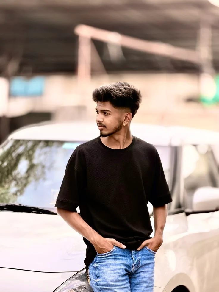 Candid Street Portrait of Young Man Leaning on White Car