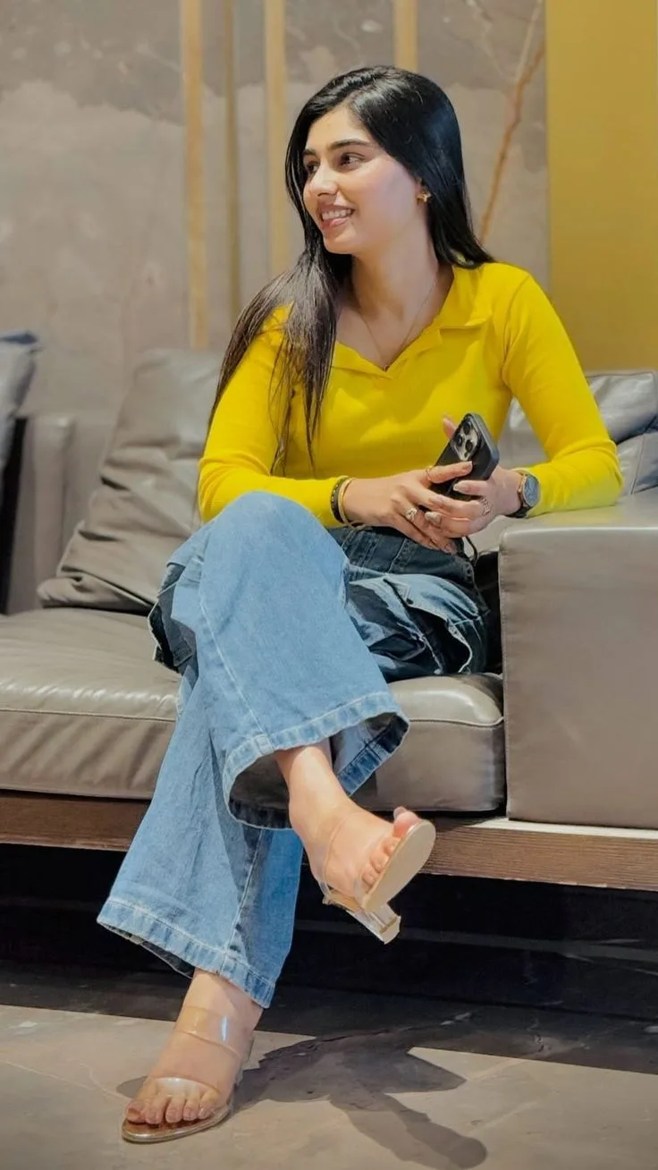Candid Lounge Portrait of Young Woman in Yellow Top and Wide-Leg Jeans