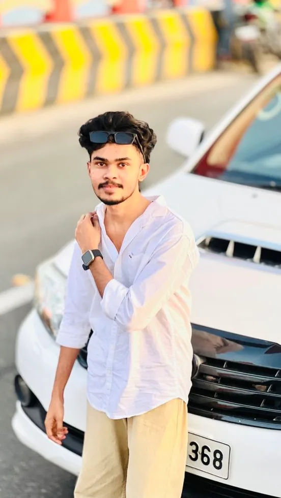 Candid Outdoor Portrait of Young Man Leaning on White SUV