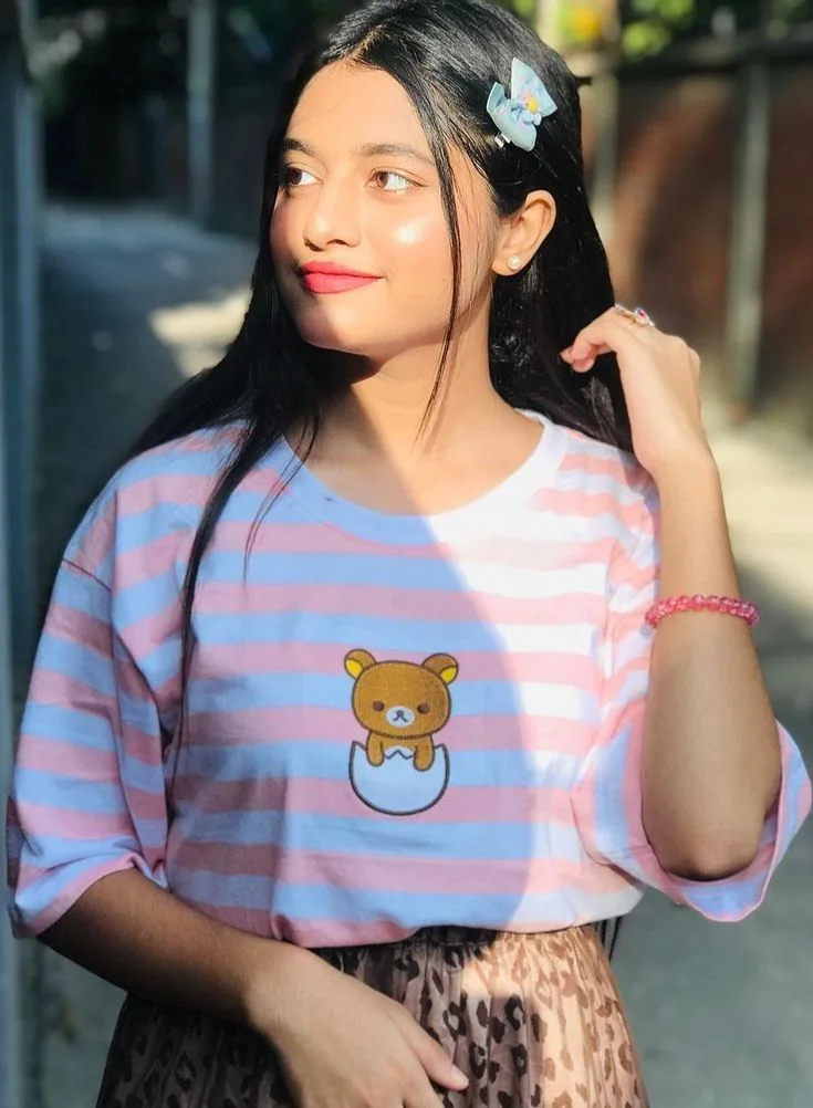 Cute Outdoor Female Portrait in Striped Graphic Tee with Hair Clip Prompt