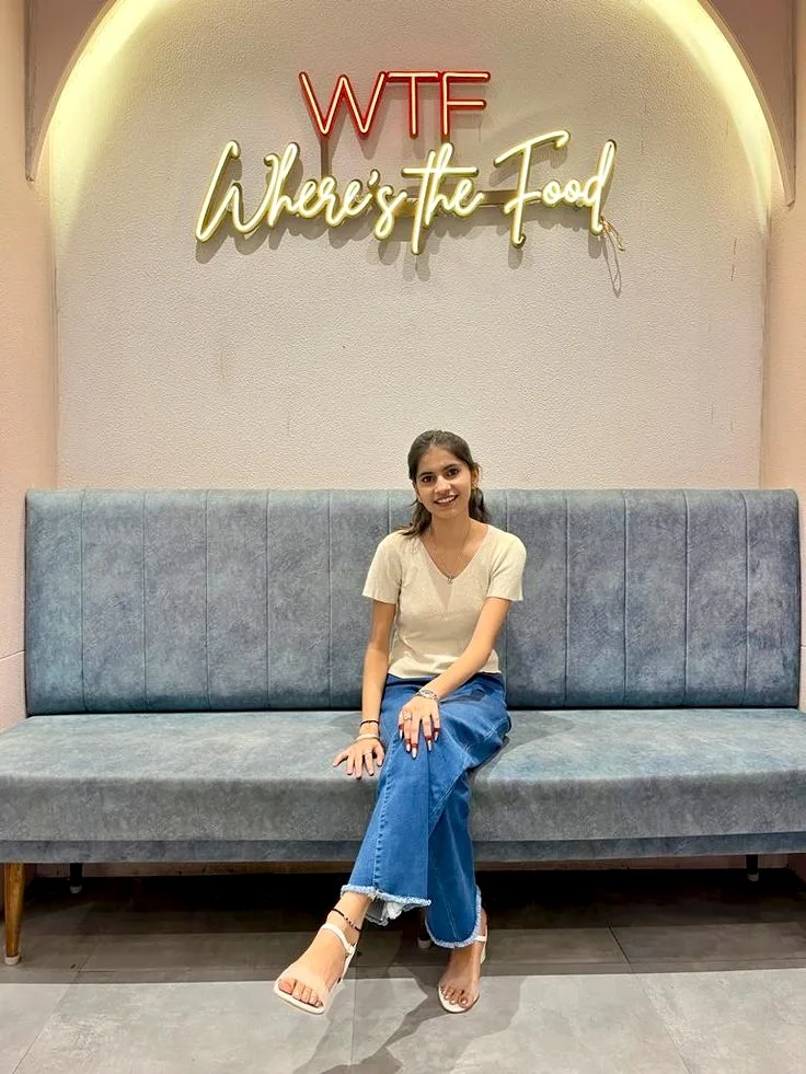 Candid Restaurant Portrait of Young Indian Woman on Blue Bench