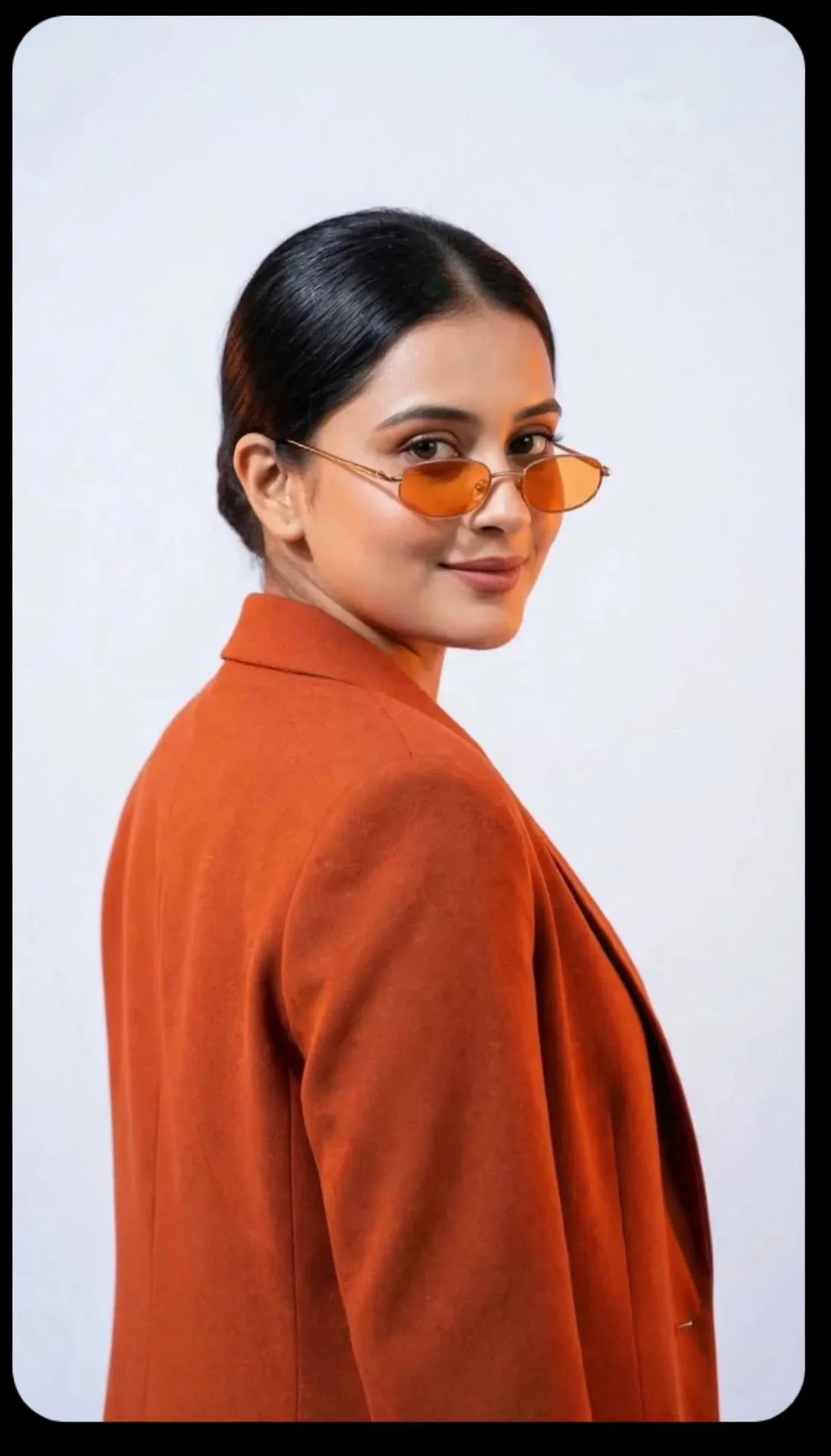 Confident Studio Portrait in Orange Blazer