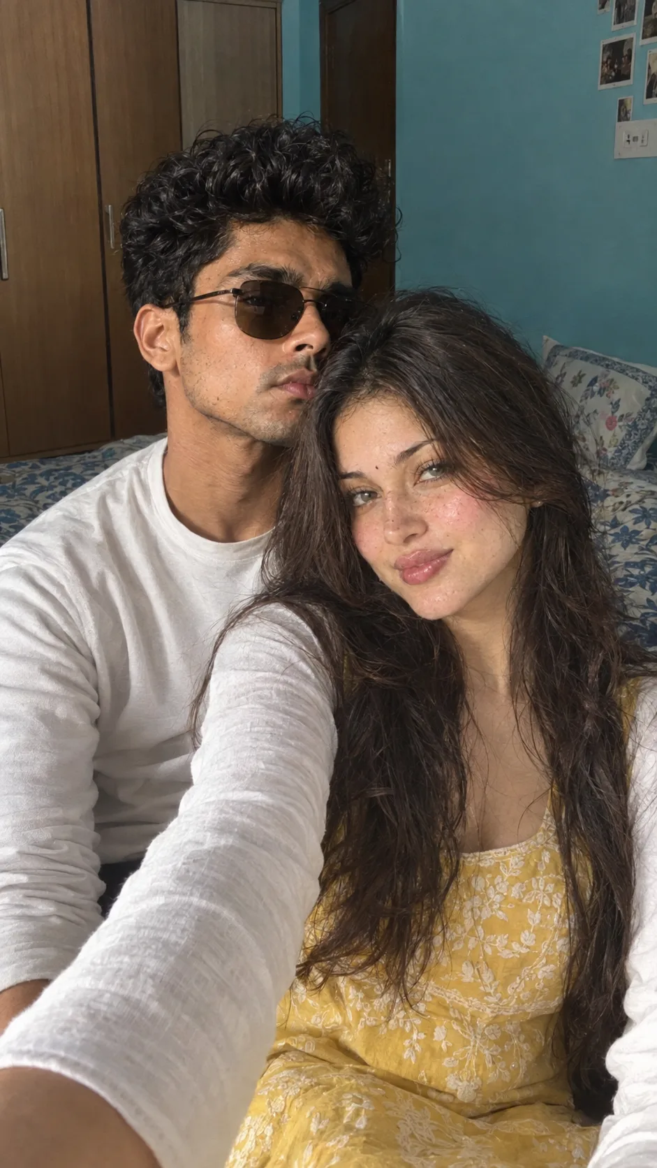Indoor selfie of a young couple sitting closely