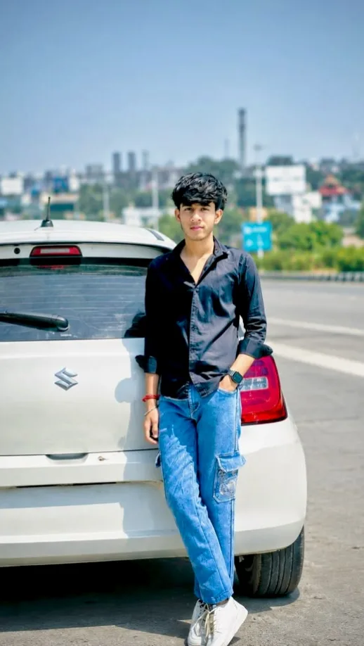 Candid Full-Body Portrait of Young Man Leaning on White Hatchback