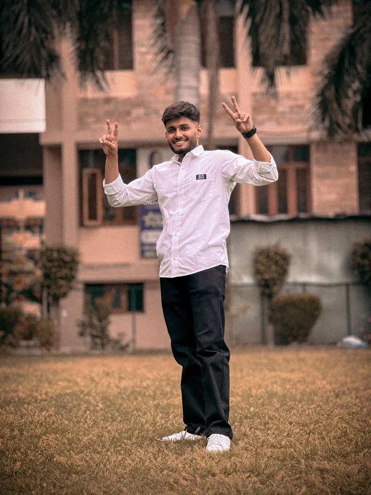 Candid Full-Length Outdoor Campus Portrait of Young Man Flashing Peace Signs