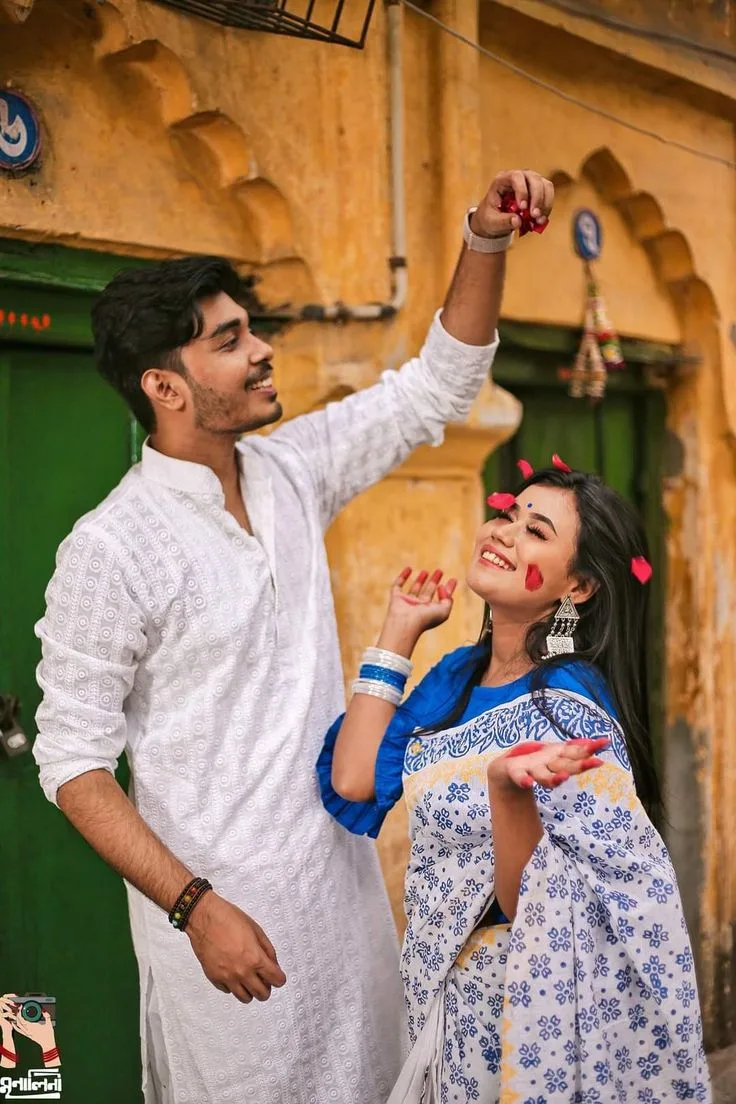Candid Festive Holi Portrait of Young Couple with Red Petals