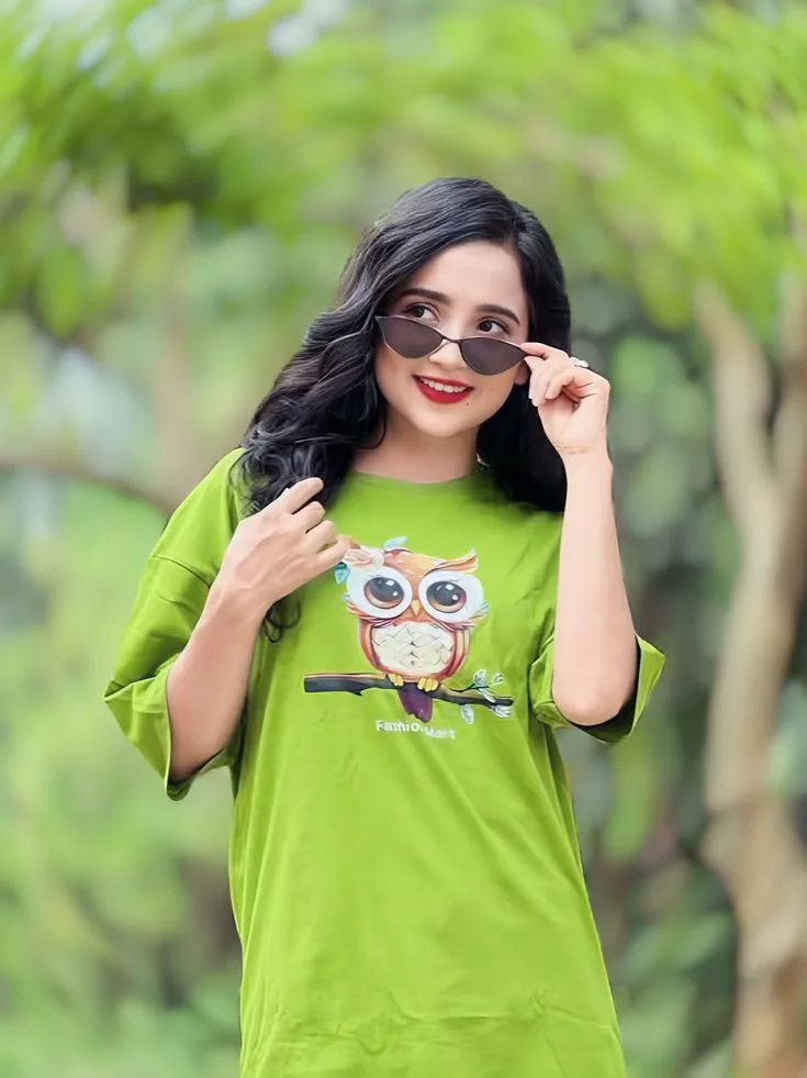Playful Outdoor Portrait of Young Indian Woman in Green Graphic Tee