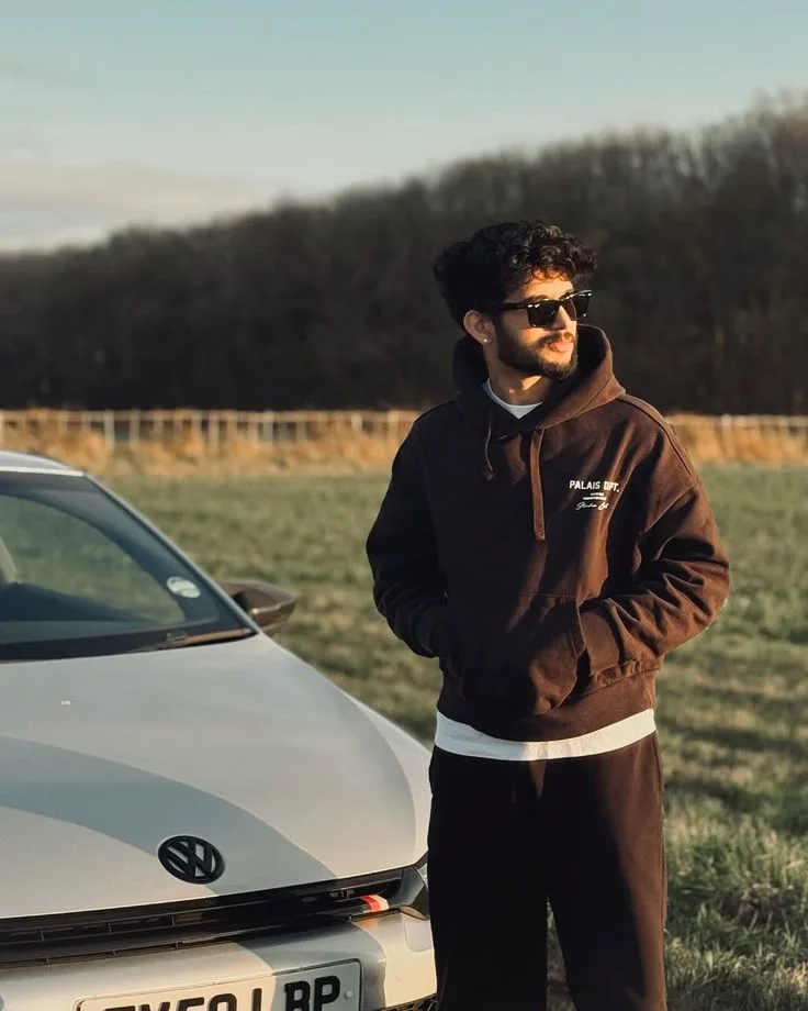 Candid Golden Hour Outdoor Portrait of Young Man Beside Silver Car